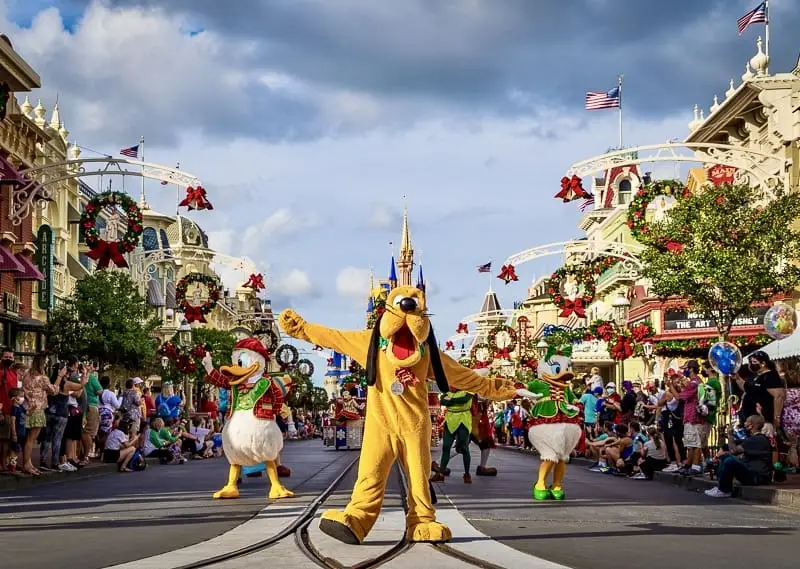 Pluto, Donald and Daisy dancing down Main Street at Mickey's Very Merry Christmas Party 2023
