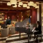 Disney Rendered Image of the Scat Cat Lounge on the Disney Treasure with Baby Grand Piano in the Center.