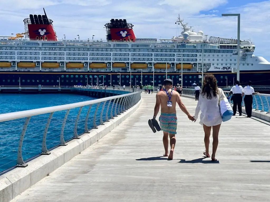 Pier at Disney Lookout Cay with Disney Magic with sparkling blue water.