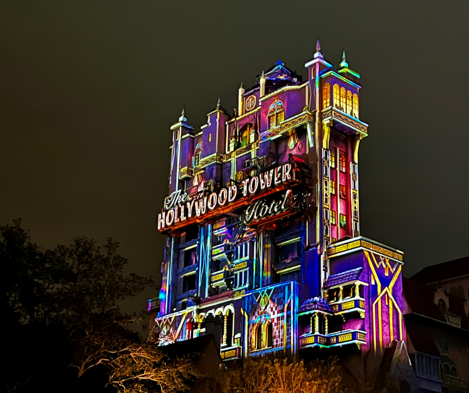 Hollywood Studios Sign on a colorfully lit up Tower of Terror at night