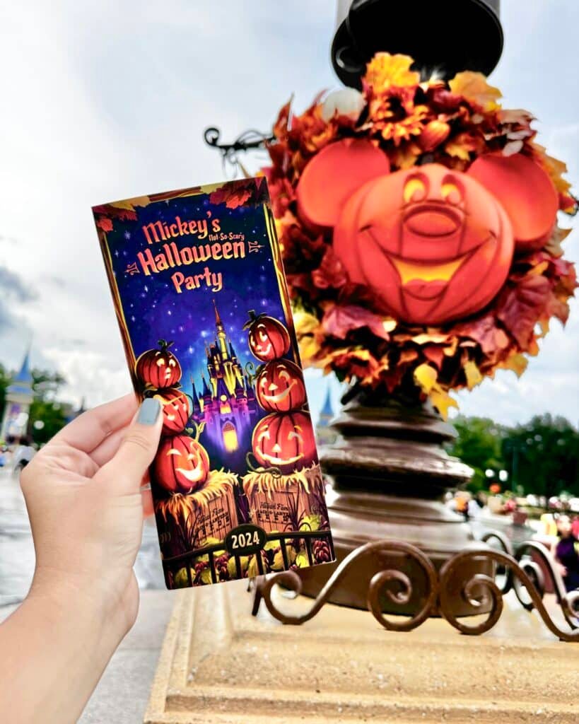 The Guide for Mickey's Not-So-Scary Halloween Party set up against a Mickey Pumpkin Head at the Party