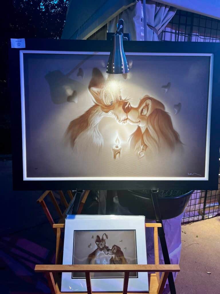 Photo of a Disney Fine Art painting of the Lady and the Tramp characters displayed during EPCOT's Festival of the Arts.