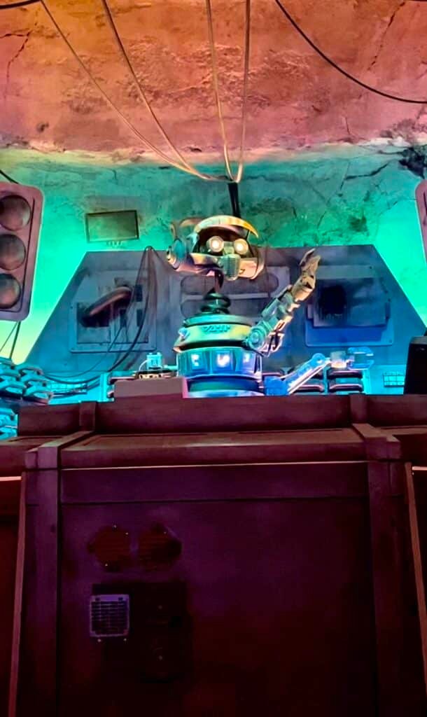 Image of DJ R3X in action playing music and dancing with a blue back light at Oga's Cantina in Disney's Hollywood Studios at Walt Disney World.