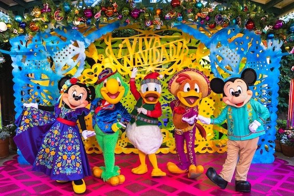 Image of Minnie, Mickey, and the Three Caballeros posing during a Viva La Navidad holiday performance at Disneyland.