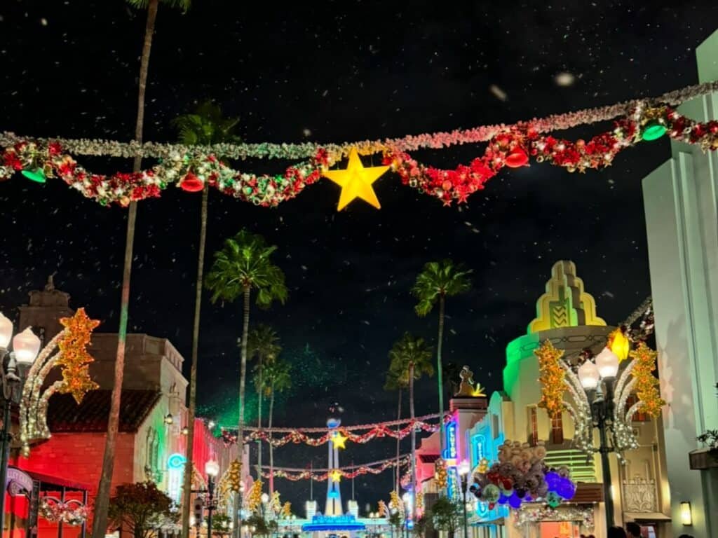 A holiday view of Disney World's Hollywood Studios with Snow falling on the streets