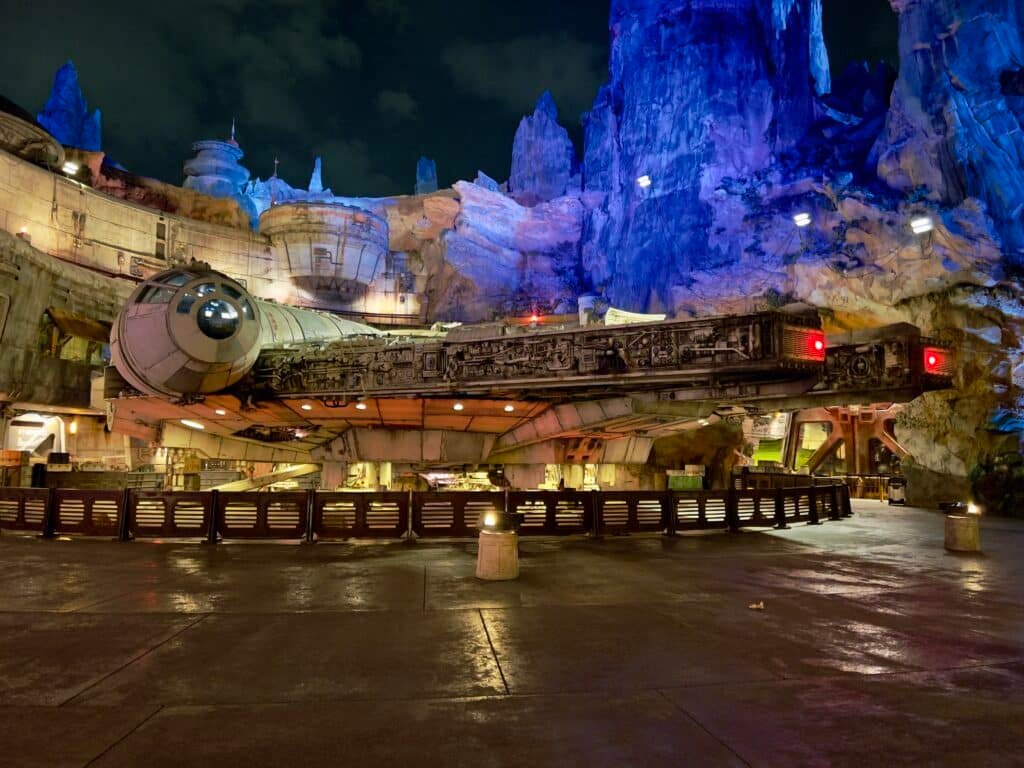 Image of the Millennium Falcon illuminated at night at Star Wars: Galaxy's Edge in Disney's Hollywood Studios