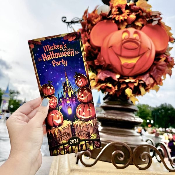 The Guide for Mickey's Not-So-Scary Halloween Party set up against a Mickey Pumpkin Head at the Party