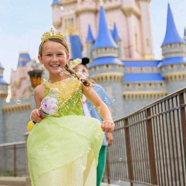 girl running through magic kingdom